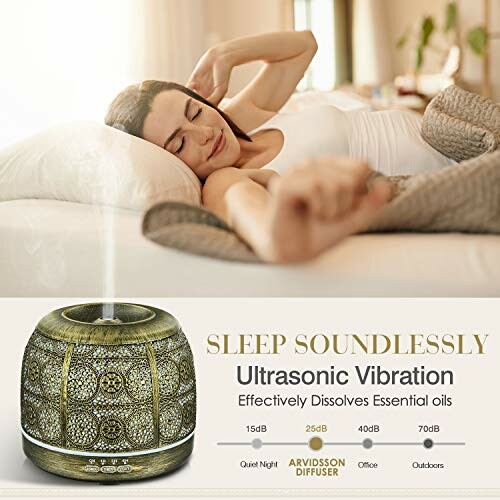 Woman relaxing on a bed with an ultrasonic diffuser emitting mist.
